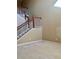 Open living area with carpeted floor and view of the staircase at 2018 Gold Spring Cv, Kissimmee, FL 34743
