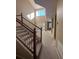 Elegant staircase with wooden handrail and carpeted steps at 2018 Gold Spring Cv, Kissimmee, FL 34743