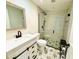 Updated bathroom with white vanity, subway tile shower, and patterned floor at 2254 Ohara Ct # 1055, Orlando, FL 32812