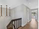 Upstairs hallway with unique light fixtures and view into bedroom at 2254 Ohara Ct # 1055, Orlando, FL 32812