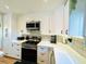Modern white kitchen with stainless steel appliances and quartz countertops at 2254 Ohara Ct # 1055, Orlando, FL 32812