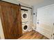 Convenient laundry room with stackable washer and dryer and barn door at 2254 Ohara Ct # 1055, Orlando, FL 32812