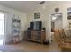 Bright living room featuring a large TV, wooden cabinet, and comfortable seating at 2408 Ming Ct, Kissimmee, FL 34744