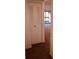 A hallway with a closet and carpet leading to a balcony at 3036 S Semoran Blvd # S, Orlando, FL 32822