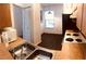 Condo kitchen features wood cabinets and laminate flooring at 3036 S Semoran Blvd # S, Orlando, FL 32822