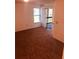 Spacious living room with carpet, large window, and access to a balcony at 3036 S Semoran Blvd # S, Orlando, FL 32822