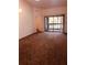 Spacious living room with carpeted floor and access to balcony at 3036 S Semoran Blvd # S, Orlando, FL 32822