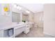 Spacious bathroom with double sinks, a large mirror, and toilet at 3150 Paradox Cir # 208, Kissimmee, FL 34746