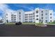 Modern condo building with ample parking and landscaped grounds at 3150 Paradox Cir # 208, Kissimmee, FL 34746