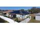 House with solar panels, pergola, fenced backyard, viewed from above at 320 Anchovie Ct, Kissimmee, FL 34759