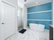Elegant bathroom featuring a freestanding tub, walk-in shower, and double vanity at 320 Anchovie Ct, Kissimmee, FL 34759