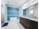 Modern bathroom with a soaking tub, double vanity, and walk-in shower at 320 Anchovie Ct, Kissimmee, FL 34759
