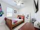 Bedroom with full-size bed, dresser, and window at 320 Anchovie Ct, Kissimmee, FL 34759