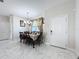 Bright dining area with a table for six and access to entryway at 320 Anchovie Ct, Kissimmee, FL 34759