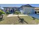 Newly built one-story home with gray siding, landscaping, and a two-car garage at 320 Anchovie Ct, Kissimmee, FL 34759