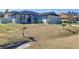 Newly built one story home with gray siding, landscaping, and a two car garage at 320 Anchovie Ct, Kissimmee, FL 34759