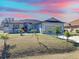 One-story home with a gray exterior, landscaping, and a two-car garage at 320 Anchovie Ct, Kissimmee, FL 34759