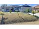 One-story home with gray exterior, landscaping, and a two-car garage at 320 Anchovie Ct, Kissimmee, FL 34759