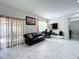 Bright living room featuring a sofa, tile floors, and access to a patio at 320 Anchovie Ct, Kissimmee, FL 34759
