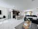 Open concept living room and kitchen with tile floors and black furniture at 320 Anchovie Ct, Kissimmee, FL 34759