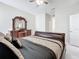 Main bedroom featuring a king-size bed, dresser, and ceiling fan at 320 Anchovie Ct, Kissimmee, FL 34759