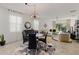 Open concept dining area with a round table and modern chandelier at 3374 Sagebrush St, Harmony, FL 34773