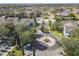 Community entrance with circular drive, parking, and townhouses visible from above at 4012 Santa Maria # 101, Kissimmee, FL 34741