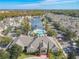 Community clubhouse, pool, and surrounding neighborhood with a pond at 4012 Santa Maria # 101, Kissimmee, FL 34741
