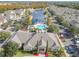 Community clubhouse, pool, and surrounding neighborhood with a pond at 4012 Santa Maria # 101, Kissimmee, FL 34741