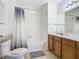 Clean bathroom with tub, double vanity, and wood cabinets at 4012 Santa Maria # 101, Kissimmee, FL 34741