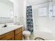 Bathroom with wooden vanity, shower/tub combo, and Star Wars decor at 4012 Santa Maria # 101, Kissimmee, FL 34741