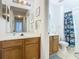 Bathroom with wooden vanity, shower/tub combo, and Star Wars decor at 4012 Santa Maria # 101, Kissimmee, FL 34741