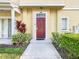 Townhome entry with red door and landscaping at 4012 Santa Maria # 101, Kissimmee, FL 34741