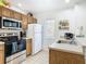 Clean kitchen featuring stainless steel appliances and wood cabinets at 4012 Santa Maria # 101, Kissimmee, FL 34741