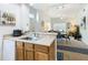 Open kitchen with breakfast bar and view into the living and dining room at 4012 Santa Maria # 101, Kissimmee, FL 34741