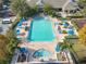 Resort-style pool with spa, deck, lounge chairs, and umbrellas at 4012 Santa Maria # 101, Kissimmee, FL 34741