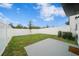 Small grassy backyard with a patio and privacy fence at 445 Madison Dr, Davenport, FL 33837