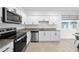 Modern kitchen with stainless steel appliances and granite countertops at 445 Madison Dr, Davenport, FL 33837