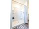 Clean bathroom with a walk-in shower and tiled walls at 680 Hillview Loop, Haines City, FL 33844