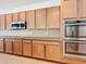 Kitchen features double oven, microwave, and wood cabinetry at 6818 Trellis Vine Loop, Windermere, FL 34786