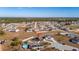 High-angle view of a house with solar panels and a pool, in a larger community at 825 Desmoines Pl, Kissimmee, FL 34759