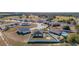 Aerial view of a residential neighborhood with houses, yards, and a pool at 825 Desmoines Pl, Kissimmee, FL 34759