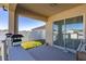 Covered back patio with sliding glass doors and fenced yard at 825 Desmoines Pl, Kissimmee, FL 34759