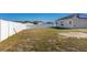 Large backyard with fenced perimeter and solar panels at 825 Desmoines Pl, Kissimmee, FL 34759