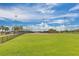 Baseball field with grassy areas and lighting at 825 Desmoines Pl, Kissimmee, FL 34759