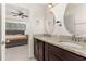 Bathroom with double vanity, granite countertops, and large mirrors at 825 Desmoines Pl, Kissimmee, FL 34759