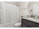 Clean bathroom with granite vanity, shower/tub combo, and white toilet at 825 Desmoines Pl, Kissimmee, FL 34759