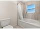 Bathroom with a shower/tub combo and window at 825 Desmoines Pl, Kissimmee, FL 34759