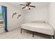 Bedroom with a king-size bed, ceiling fan, and tile floor at 825 Desmoines Pl, Kissimmee, FL 34759