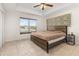 Main bedroom with king bed and ceiling fan at 825 Desmoines Pl, Kissimmee, FL 34759